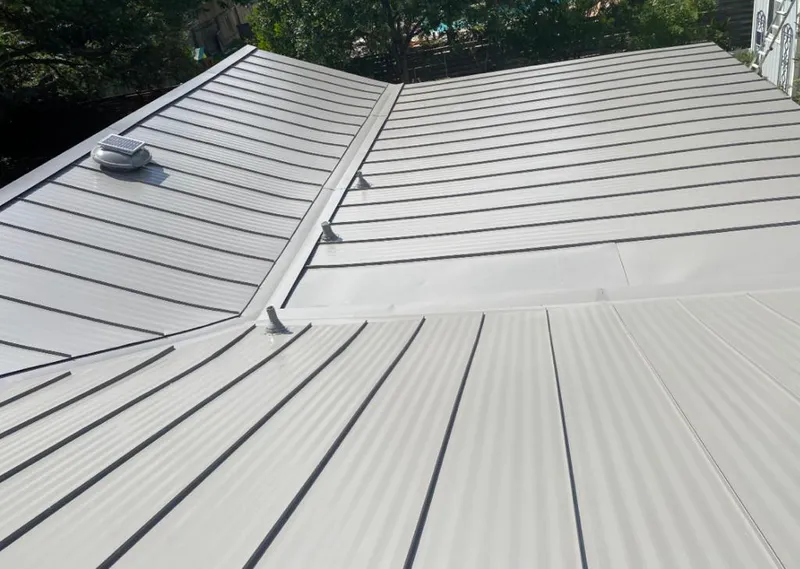 Solar attic fan installed on a metal roof for Roof Ventilation in Franconia